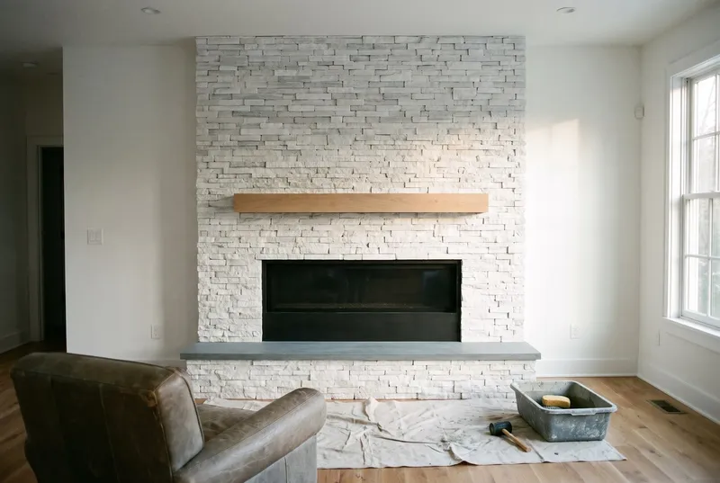 white ledgestone fireplace wall in a modern living room